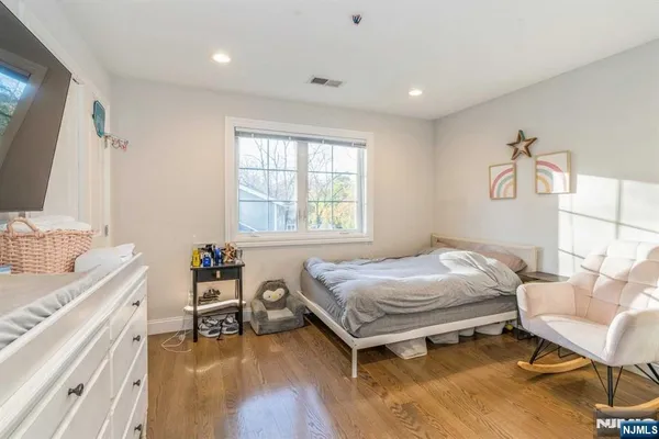 a bedroom with a bed and a chair in it
