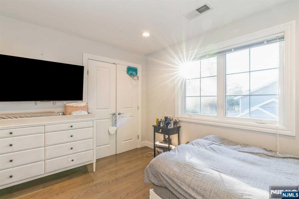 5 Benjamin Road Tenafly, NJ 07670 - Photo 24 of 50 a bedroom with a bed and a flat screen tv