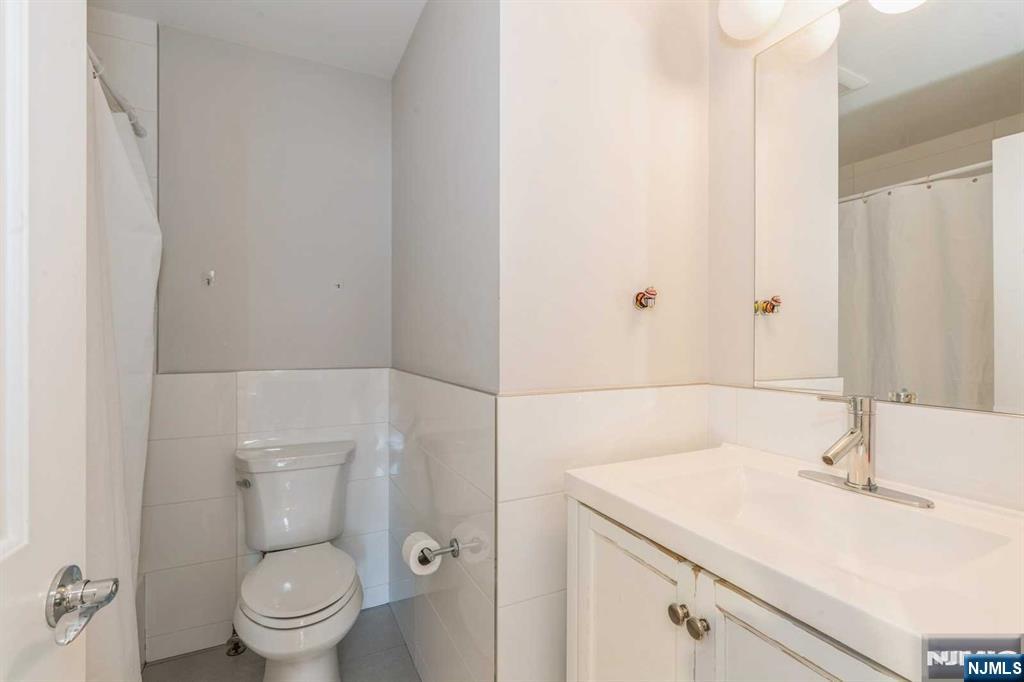 5 Benjamin Road Tenafly, NJ 07670 - Photo 26 of 50 a bathroom with a sink toilet and vanity