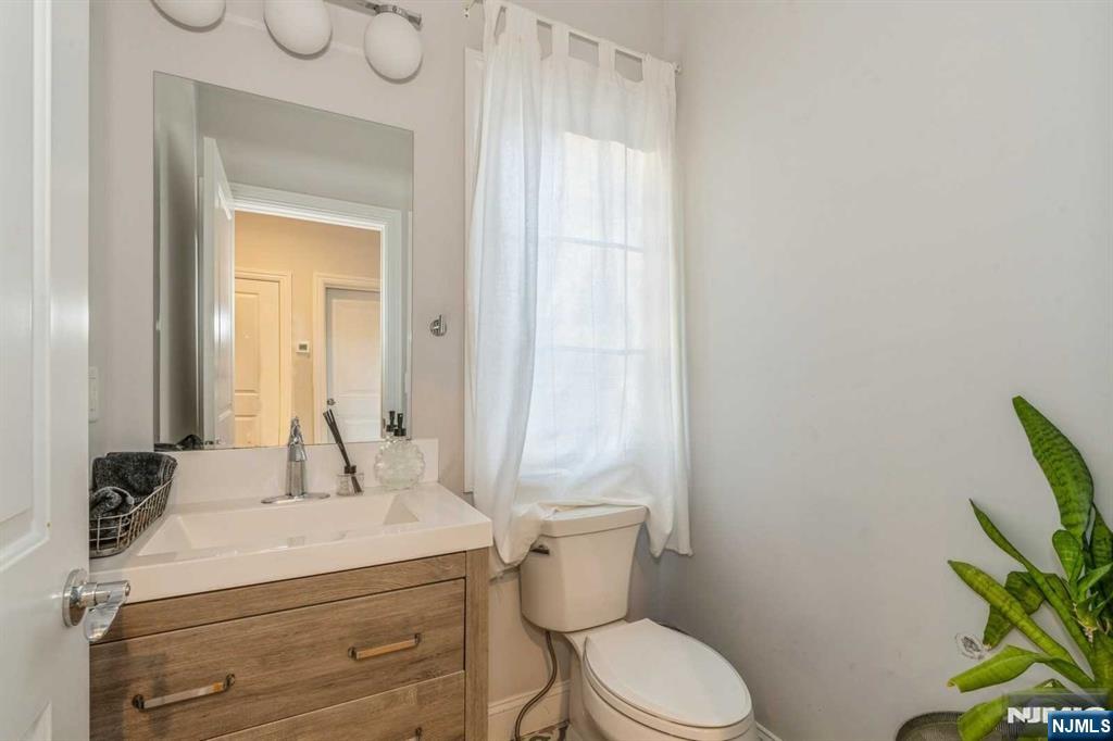 5 Benjamin Road Tenafly, NJ 07670 - Photo 32 of 50 a bathroom with a granite countertop sink and a mirror