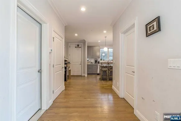 a view of a hallway with wooden floor