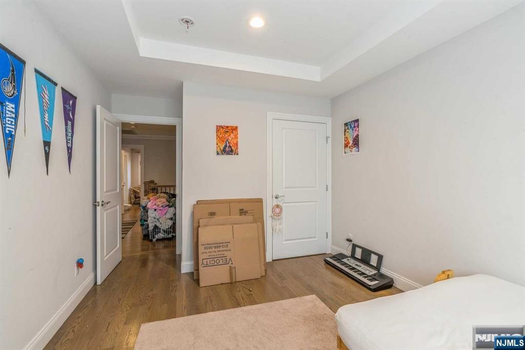 5 Benjamin Road Tenafly, NJ 07670 - Photo 37 of 50 a living room with furniture and a baby crib