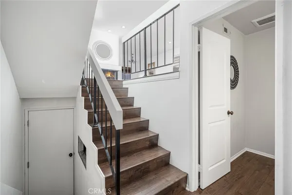 a view of entryway with wooden floor and stairs