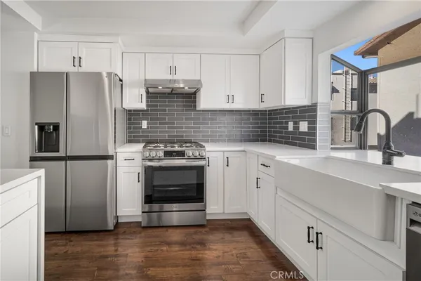 a kitchen with stainless steel appliances a refrigerator sink and cabinets