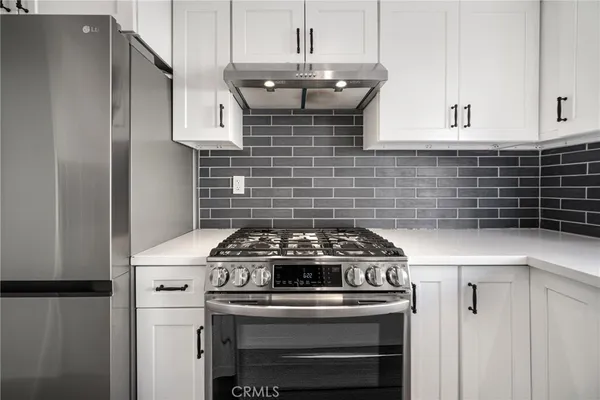 a stove top oven sitting inside of a kitchen
