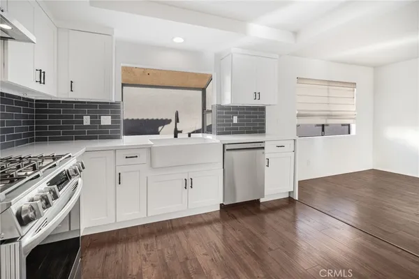 a kitchen with a stove a sink and a microwave