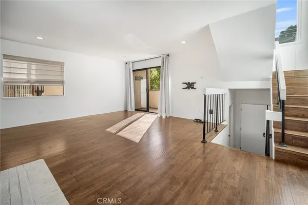 a view of a room with wooden floor and staircase