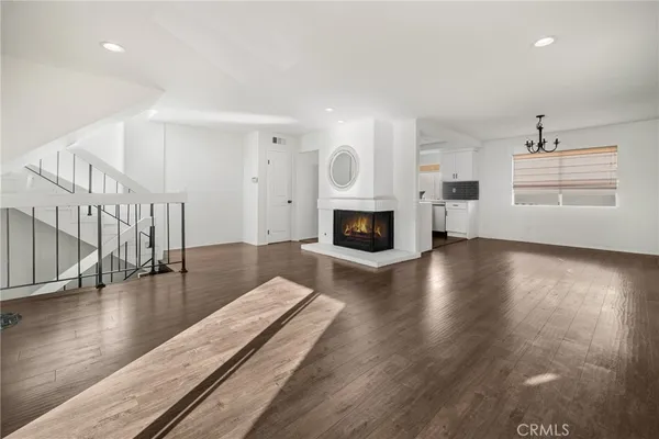 a living room with fireplace furniture and a wooden floor