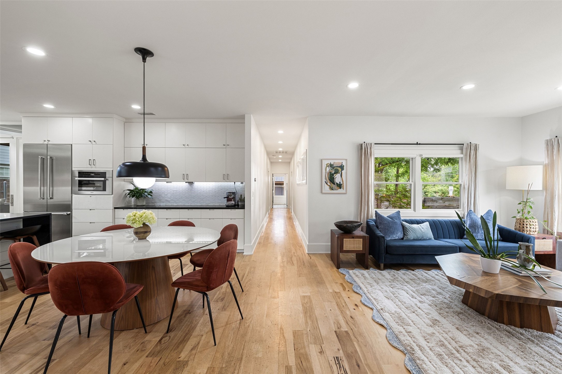 2000 Rundell Place Austin, TX 78704 - Photo 11 of 38 An open concept living and dining space seamlessly blends contemporary design with warm, natural wood floors.