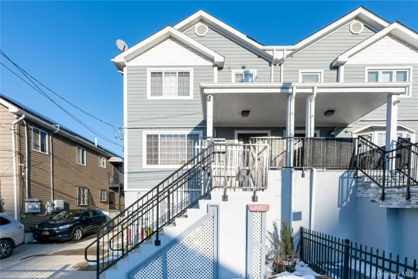 a view of house along with deck and outdoor seating