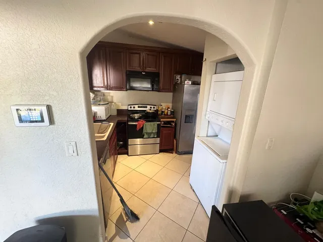 a kitchen with stainless steel appliances a refrigerator and a stove top oven
