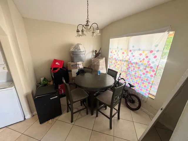 a view of a dining room with furniture and chandelier