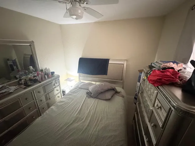 a bedroom with a bed and a sink