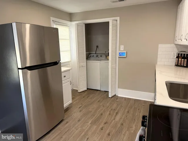 a metallic refrigerator freezer sitting in a kitchen