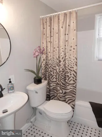 a white toilet sitting next to a bathroom sink