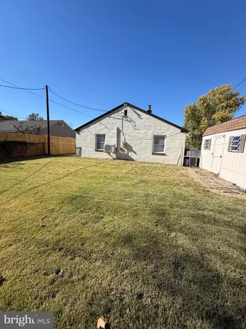 a big house with a big yard and large trees