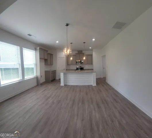 a view of a kitchen with a sink and wooden floor