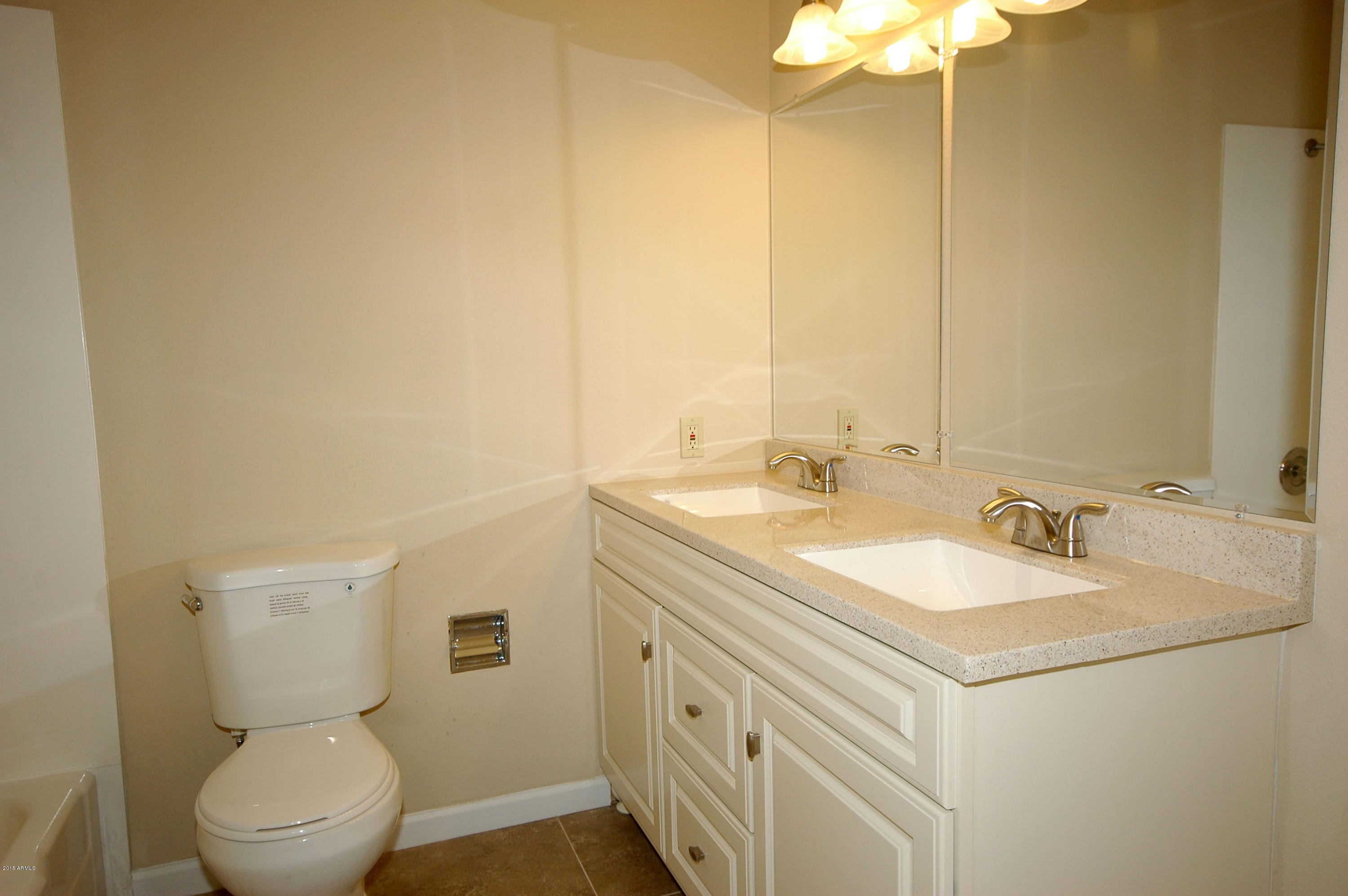 3151 West Redfield Road Phoenix, AZ 85053 - Photo 11 of 15 a bathroom with a sink a toilet and a mirror
