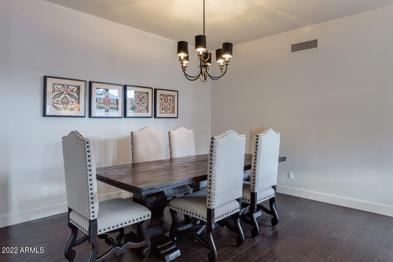 10801 East Happy Valley Road, Unit 74 Scottsdale, AZ 85255 - Photo 12 of 27 a view of a dining room with furniture and wooden floor