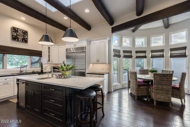 a roof deck with table and chairs potted plants