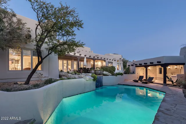 a view of a swimming pool with outdoor seating