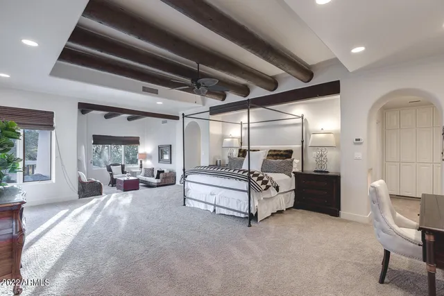 a spacious bedroom with a bed and a table