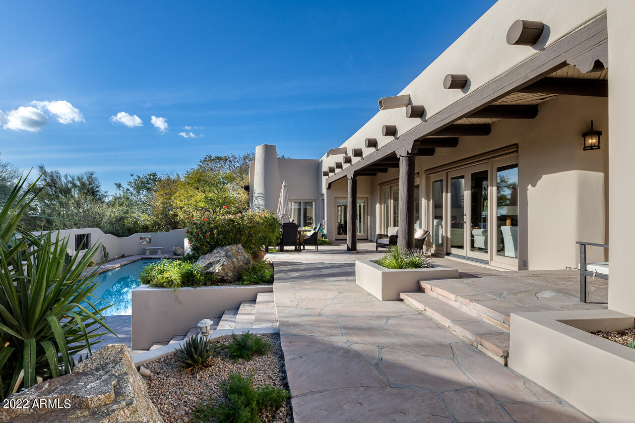 10801 East Happy Valley Road, Unit 74 Scottsdale, AZ 85255 - Photo 3 of 27 a view of a building with potted plants and a fountain