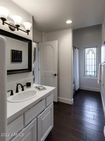 a living room with furniture fireplace and a large window