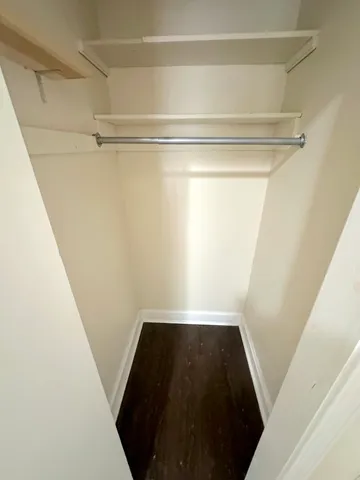 a view of closet with wooden floor