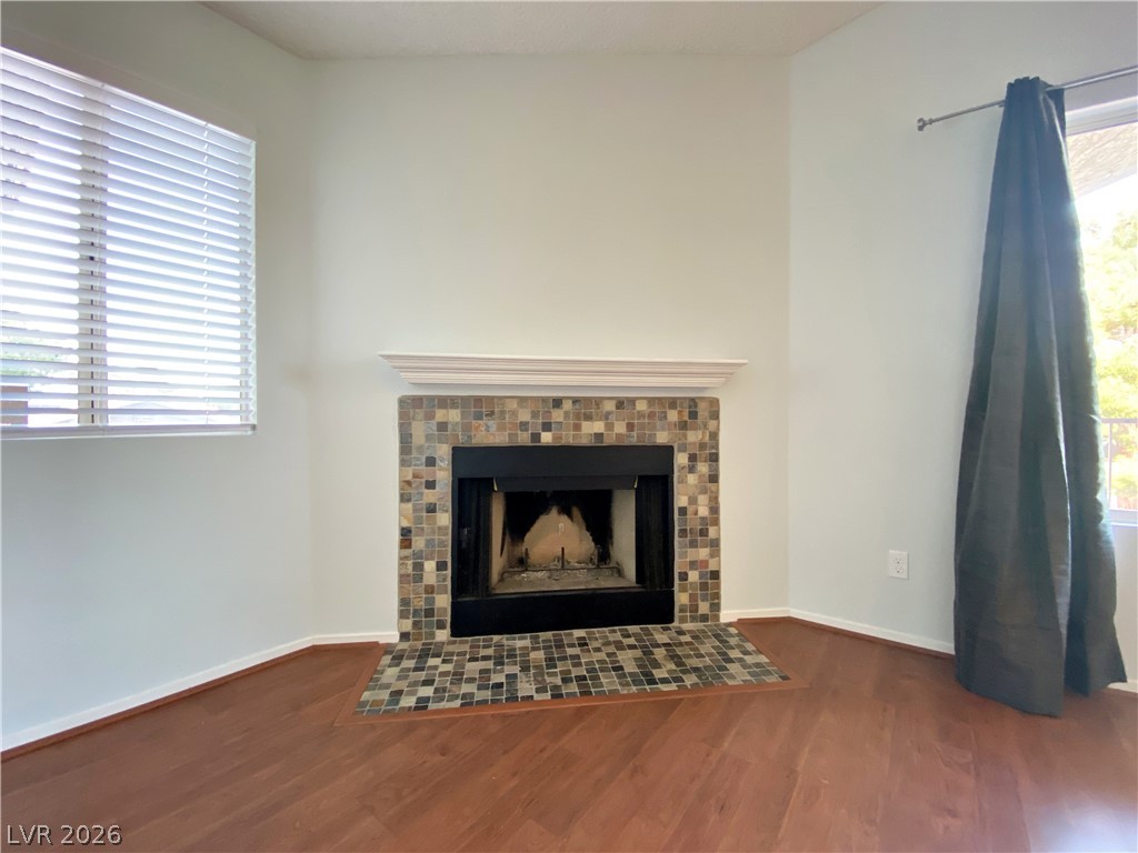 1575 West Warm Springs Road, Unit 1024 Henderson, NV 89014 - Photo 24 of 25 A corner fireplace with a tiled hearth warms this inviting living space.