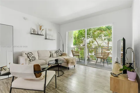 a living room with furniture and a floor to ceiling window