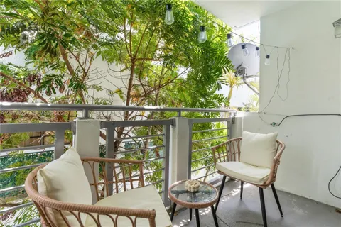 a view of a chairs and table in the balcony