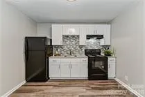 a kitchen with a refrigerator and cabinets
