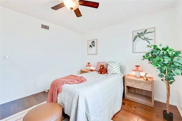 a bedroom with a bed and a potted plant