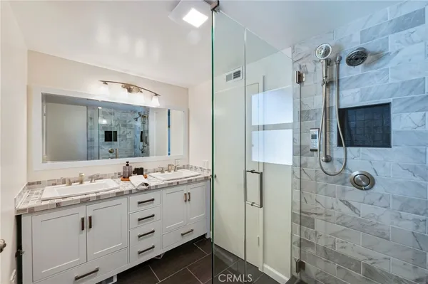 a bathroom with a double vanity sink mirror and double