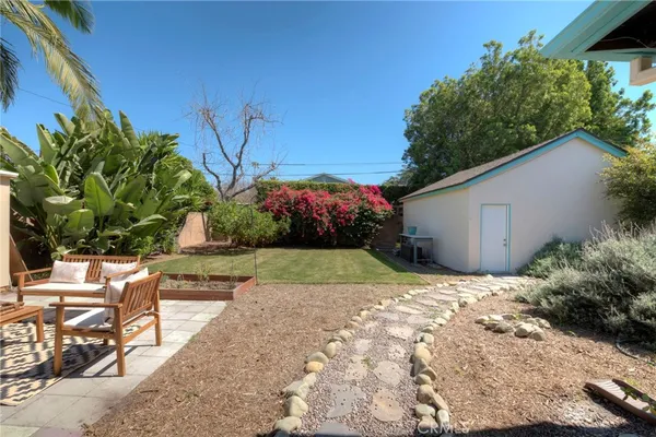 a view of backyard with plants and outdoor seating