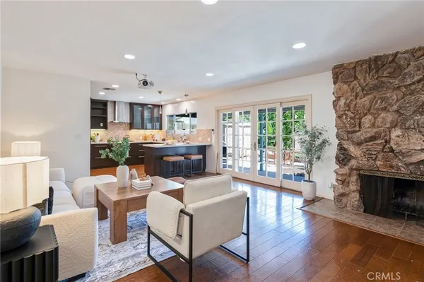 a dining room with furniture wooden floor and a fireplace