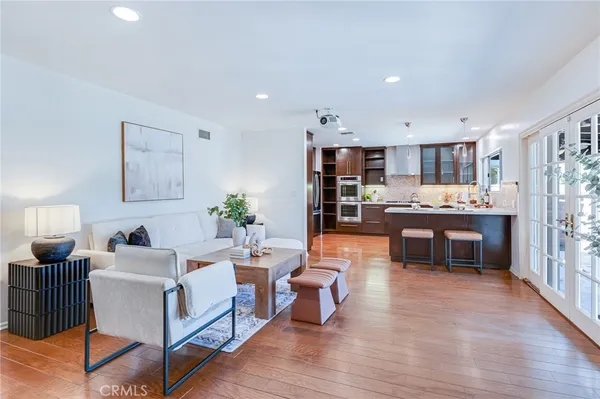 a living room with stainless steel appliances kitchen island granite countertop furniture and a kitchen view