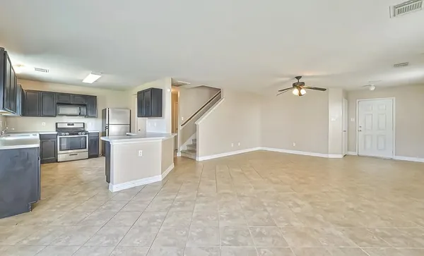 a view of kitchen with furniture and refrigerator