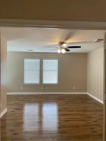 a view of a room with wooden floor and window