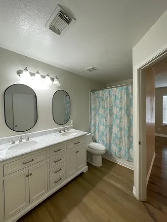 a bathroom with a double vanity sink and a mirror