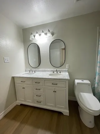 a bathroom with double vanity sink and a mirror