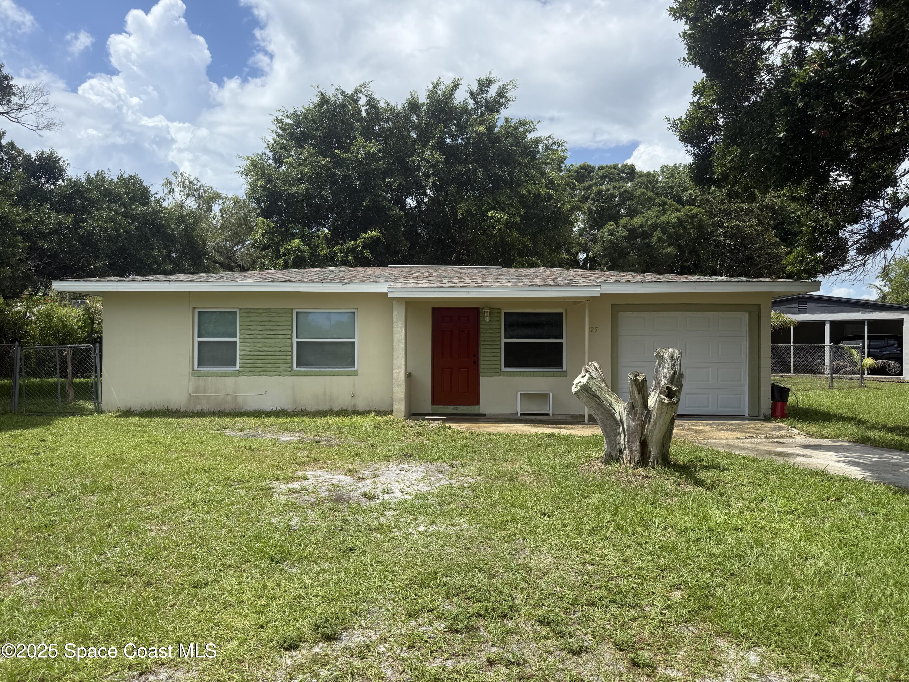 325 Patrick Circle Melbourne, FL 32901 - Photo 1 of 15 a backyard of a house with table and chairs