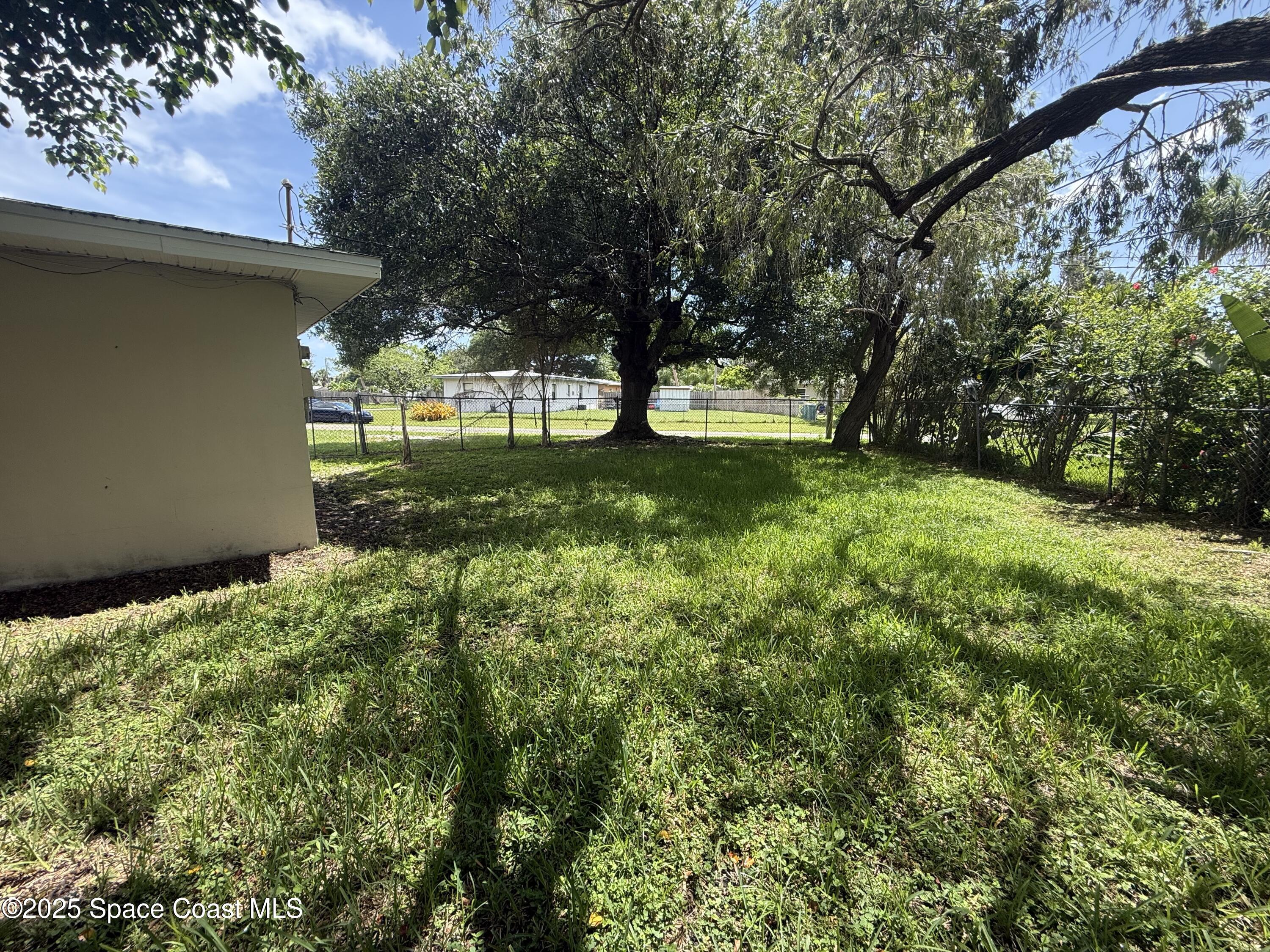 325 Patrick Circle Melbourne, FL 32901 - Photo 14 of 15 a view of backyard with large trees