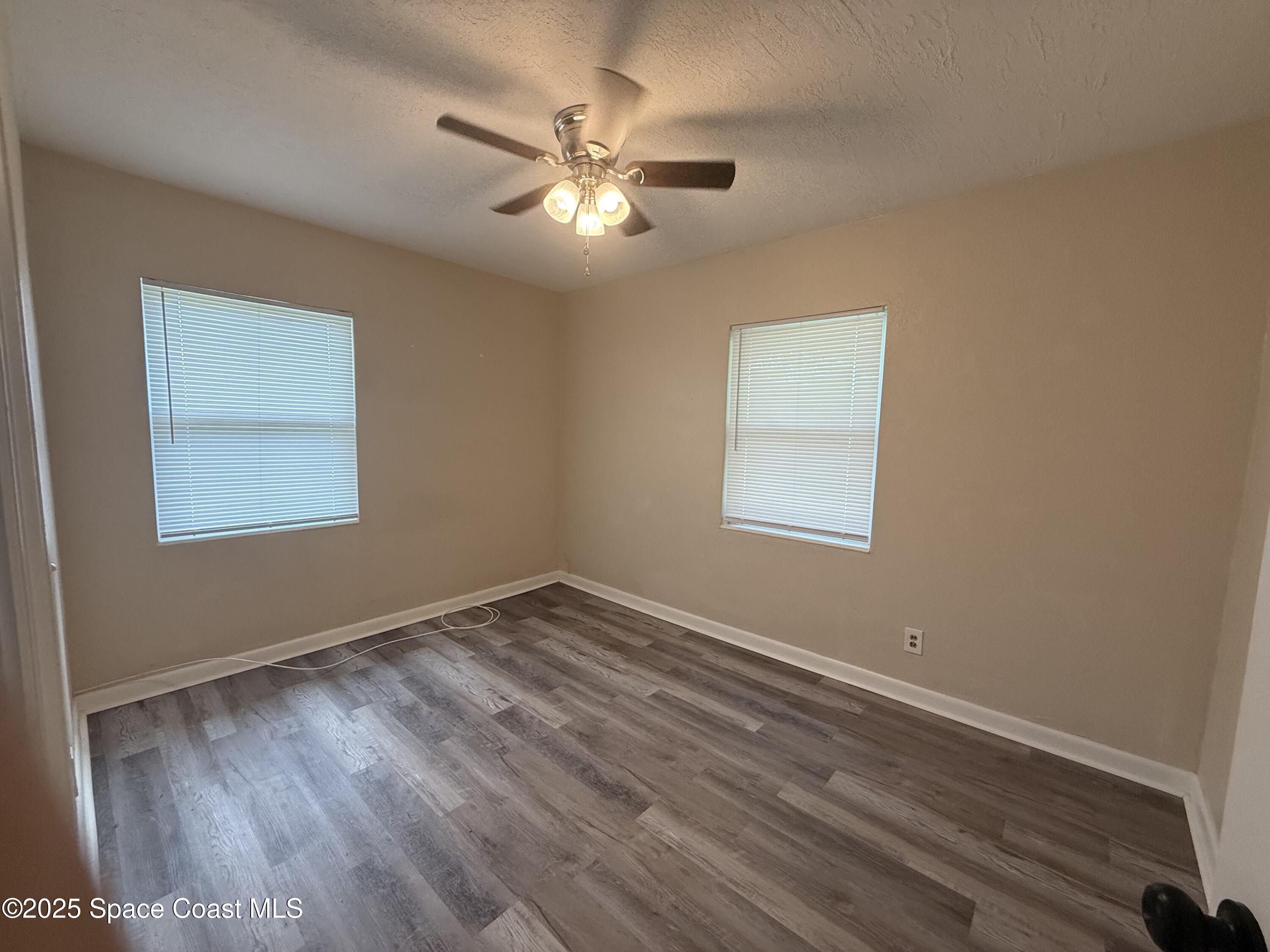 325 Patrick Circle Melbourne, FL 32901 - Photo 6 of 15 a view of an empty room with wooden floor and a window