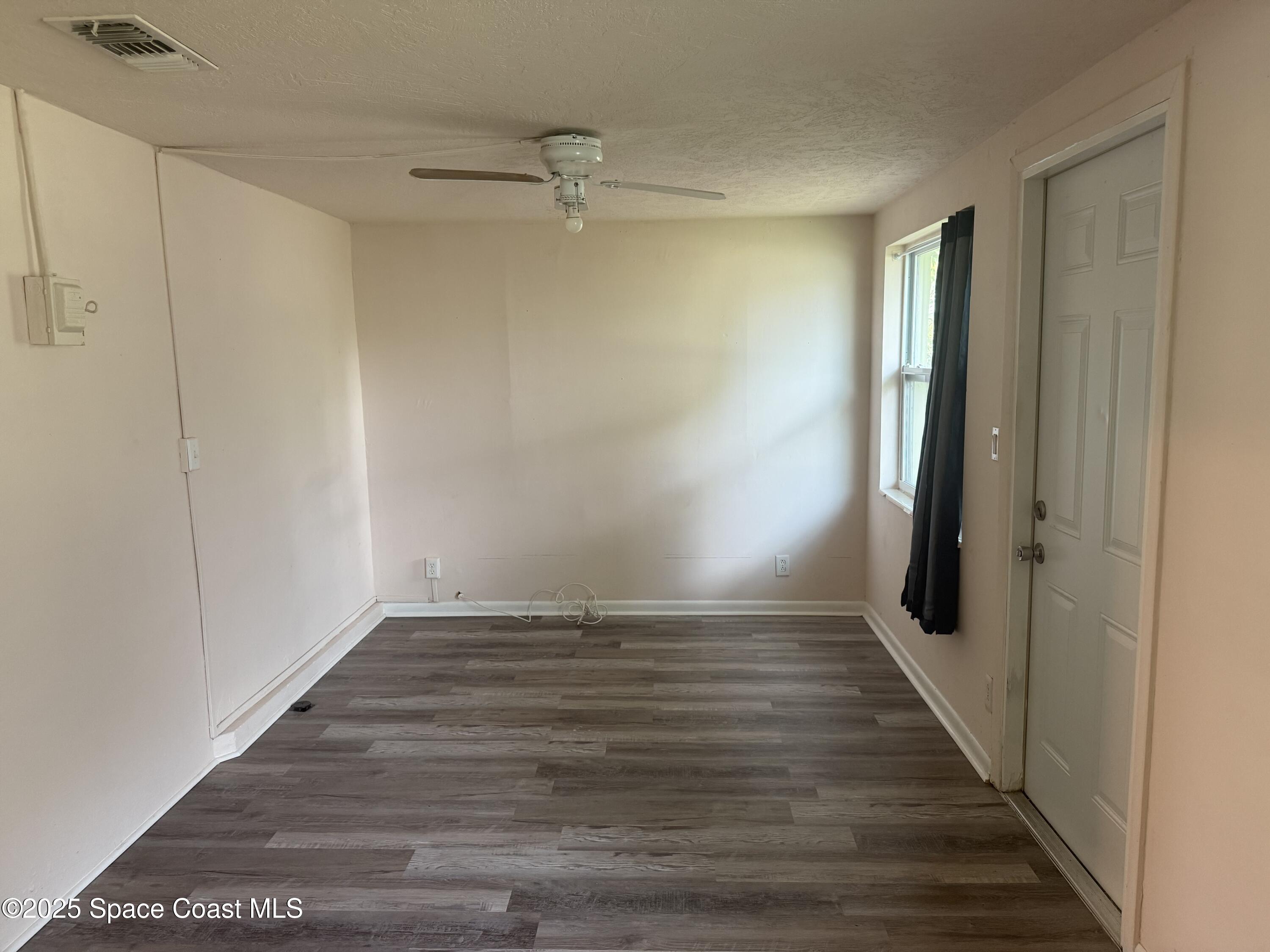 325 Patrick Circle Melbourne, FL 32901 - Photo 8 of 15 a view of an empty room with wooden floor