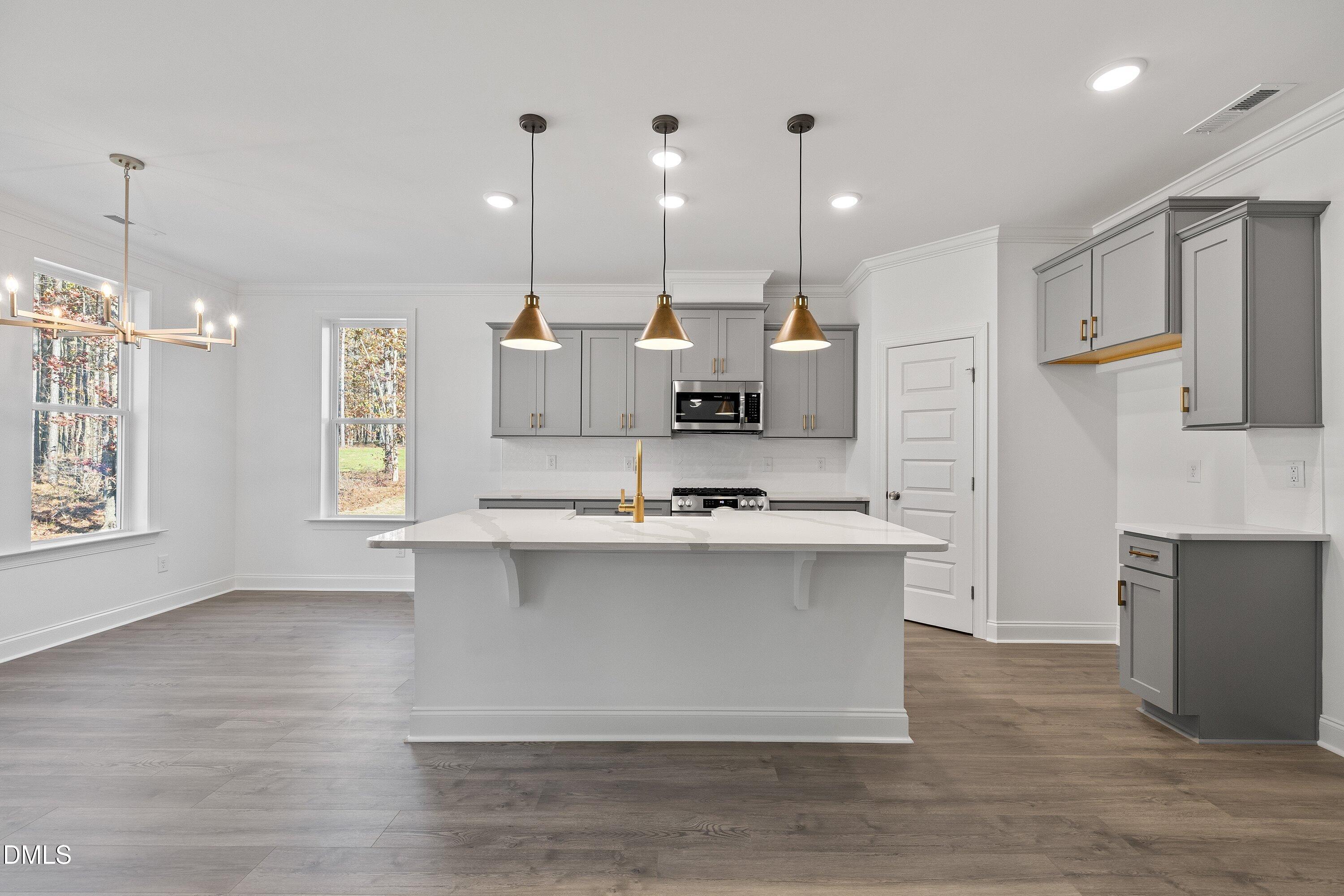 62 West Victoria Ridge Drive, Unit 19 Selma, NC 27576 - Photo 5 of 26 a large kitchen with cabinets a sink a window and stainless steel appliances