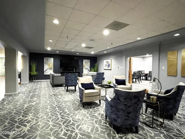a living room with furniture a rug and a flat screen tv