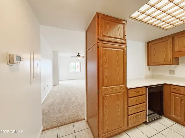 a kitchen with a refrigerator and cabinets