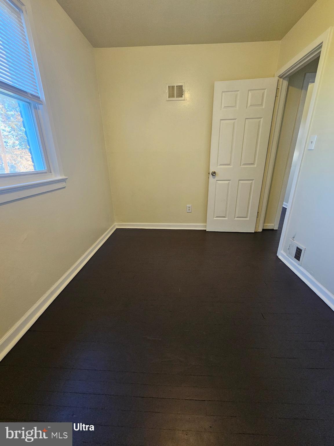 3855 28th Avenue, Unit 37 Temple Hills, MD 20748 - Photo 3 of 11 an empty room with a door